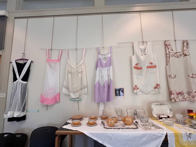a table with a table with dishes and aprons.