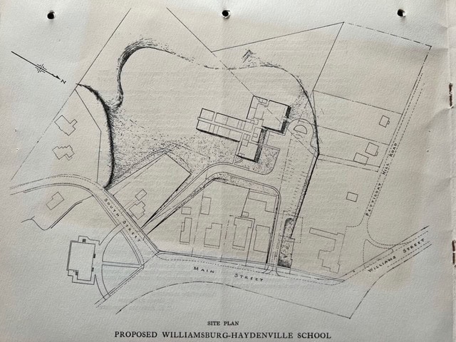 site plan drawing showing the layout of the proposed williamsburg haydenville school, adjacent roads, surrounding buildings, and natural features.