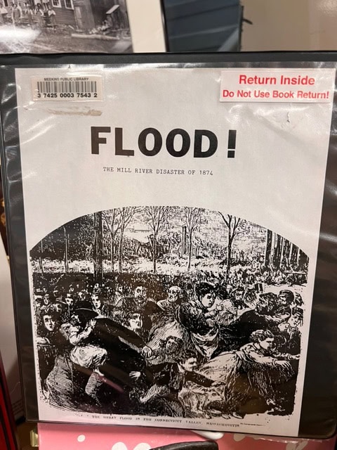a book titled "flood! the mill river disaster of 1874" features a black and white illustration of people fleeing a flood; a “return inside” sticker is on the cover.