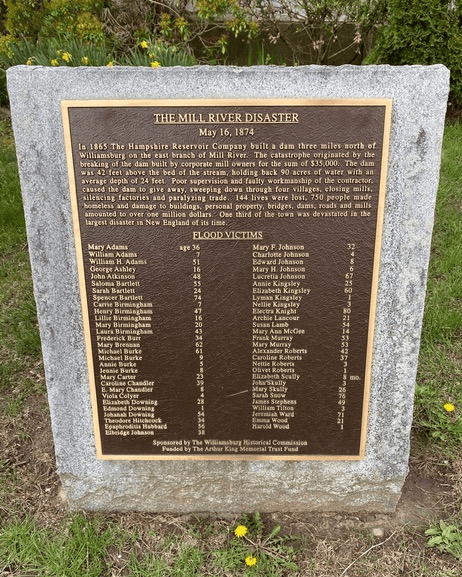 a bronze plaque titled "the mill river disaster" details the 1874 flood in williamsburg, ma, and lists the names and ages of 139 victims.