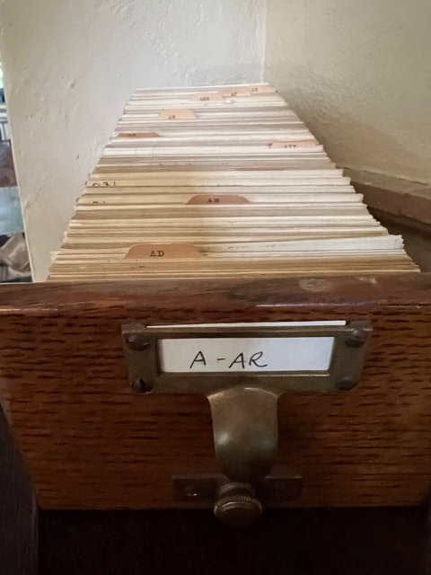an open wooden card catalog drawer labeled "a ar," filled with alphabetical index cards separated by tabbed dividers.