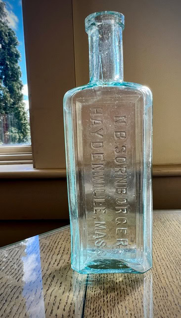 The bottle standing upright