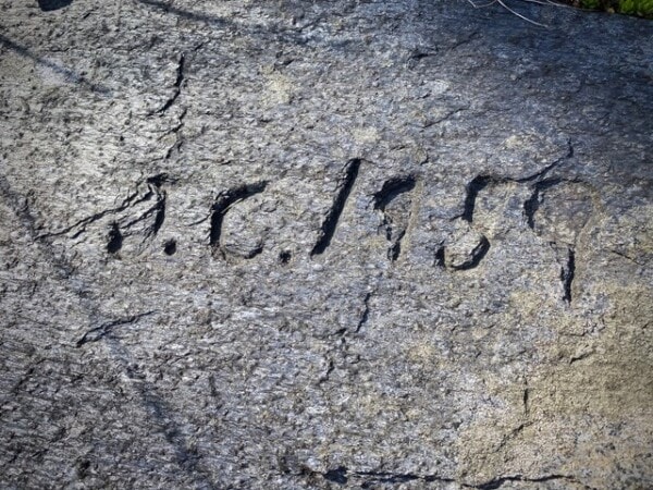a date, “a.d. 1559,” is carved into a rough stone surface.