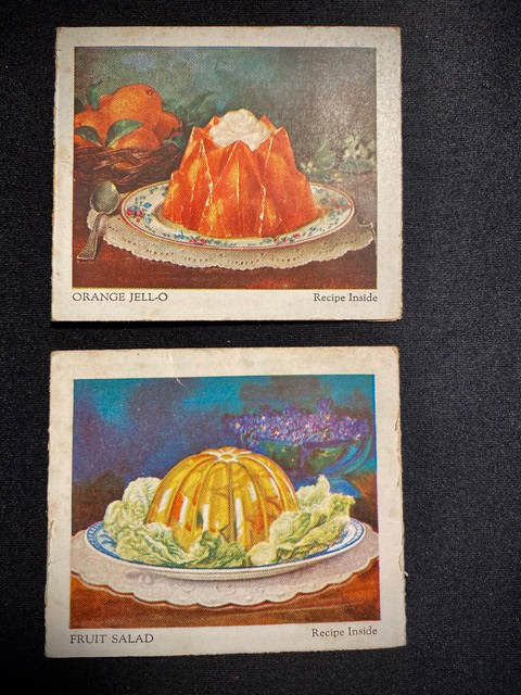 two vintage recipe cards: one shows an orange jell o mold with whipped cream, the other a yellow fruit salad mold on lettuce, both on decorative plates.