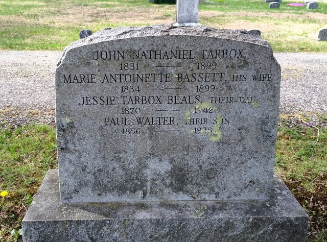 gravestone for john nathaniel tarbox, marie antoinette bassetti, jessie tarbox beals, and paul walter, listing their birth and death years.