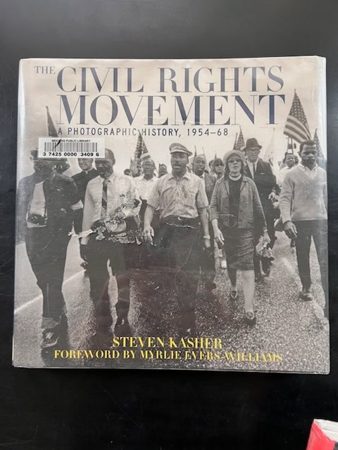 cover of the book "the civil rights movement: a photographic history, 1954–68" by steven kasher, featuring a historic black and white protest march.