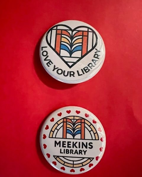 two round buttons on a red background; the top says "love your library" with a heart and books, the bottom says "meekins library" with a similar design and small red hearts.