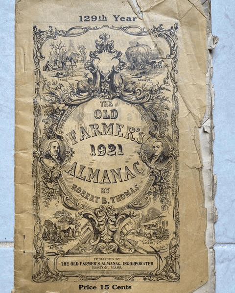 worn cover of "the old farmer's almanac 1921" by robert b. thomas, featuring ornate illustrations and the price of 15 cents.