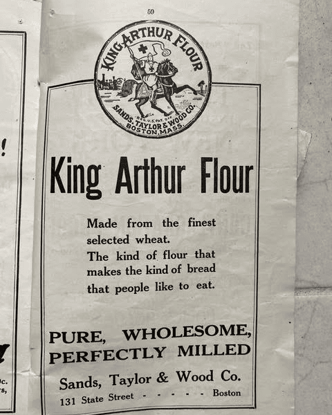black and white vintage advertisement for king arthur flour, highlighting its quality, wholesomeness, and origin from sands, taylor & wood co., boston, ma.