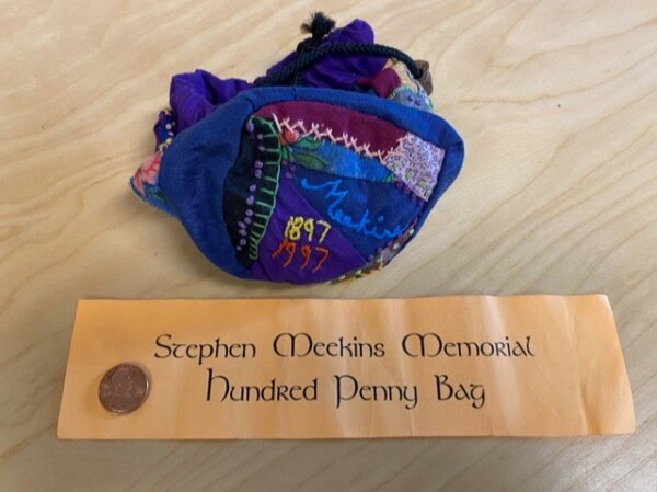 a colorful drawstring bag labeled 