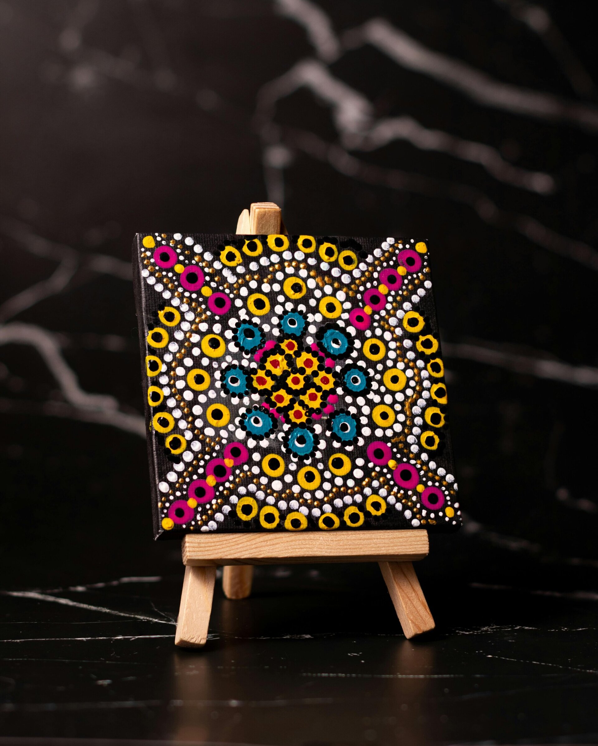 A tiny canvas with a pattern painted on it.