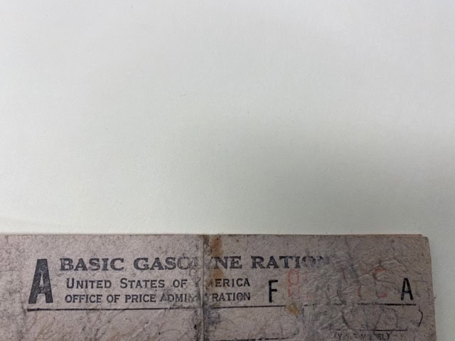 a portion of a vintage u.s. office of price administration gasoline ration card labeled "a basic gasoline ration.