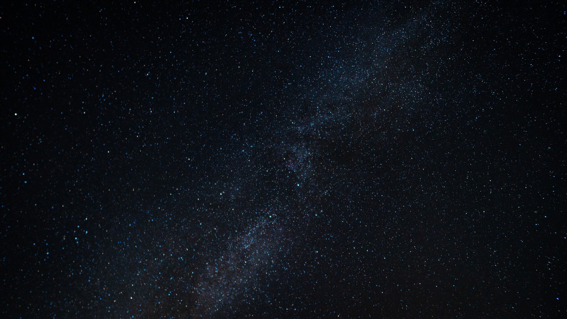 the milky way galaxy stretched across a dark night sky filled with stars.