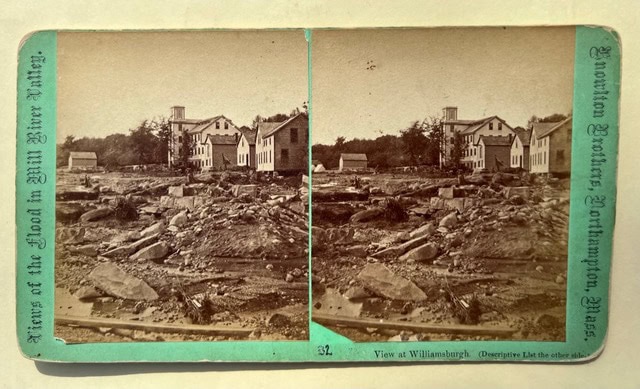 black and white stereoscopic photo of flood aftermath in williamsburg, showing damaged buildings and debris with trees in the background.