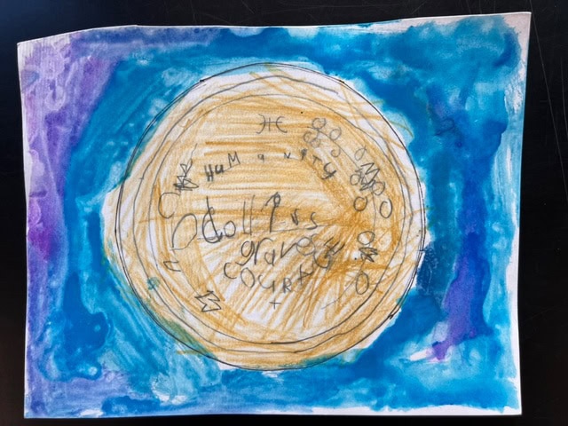 a crayon and watercolor drawing shows a large yellow circle with scribbled letters and words, surrounded by a blue and purple background.