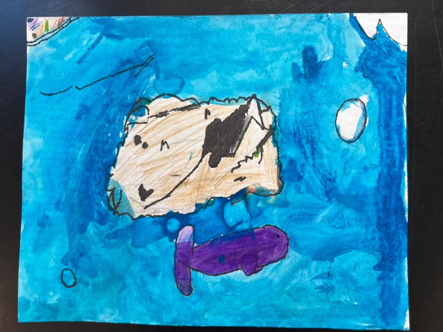 a drawing of a tan rock and a purple fish underwater, surrounded by blue water with a few bubbles and a white oval object.