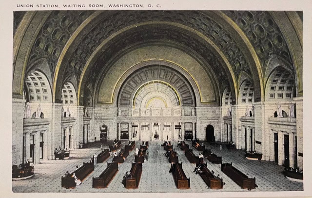 wide view of the union station waiting room in washington, d.c., featuring arched ceilings, large windows, and rows of benches with people seated.
